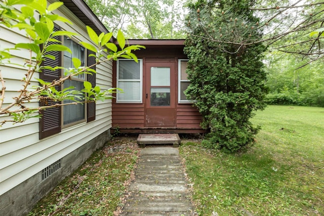 5665 N Sturgeon Rd, Midland, MI 48624 - view of exterior entry featuring a yard