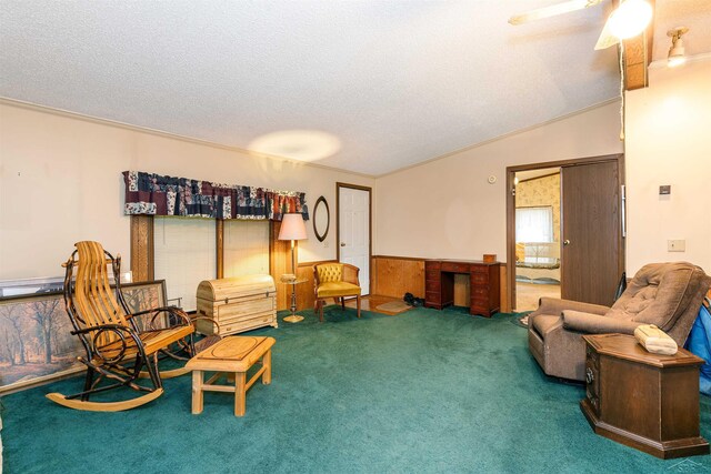 5665 N Sturgeon Rd, Midland, MI 48624 - sitting room featuring carpet, a textured ceiling, a ceiling fan, and lofted ceiling