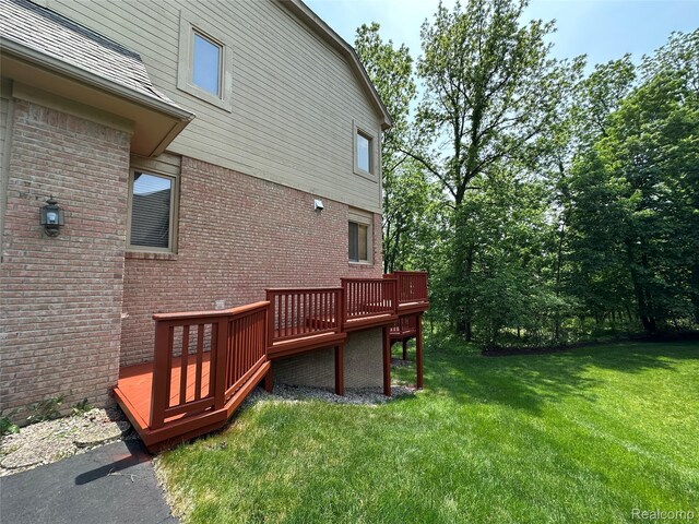 6601PEMBRIDGEHILL Pembridge Hl, West Bloomfield, MI 48322 - back of property with brick siding, a wooden deck, and a yard