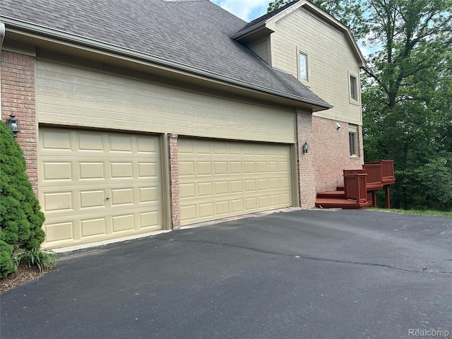 6601PEMBRIDGEHILL Pembridge Hl, West Bloomfield, MI 48322 - view of side of home featuring brick siding, a shingled roof, and driveway