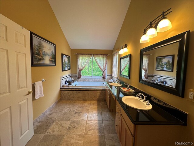 6601PEMBRIDGEHILL Pembridge Hl, West Bloomfield, MI 48322 - full bathroom featuring stone tile flooring, lofted ceiling, double vanity, a bath, and baseboards