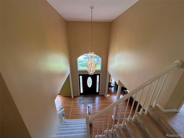 6601PEMBRIDGEHILL Pembridge Hl, West Bloomfield, MI 48322 - foyer with a chandelier, baseboards, a towering ceiling, wood finished floors, and stairway