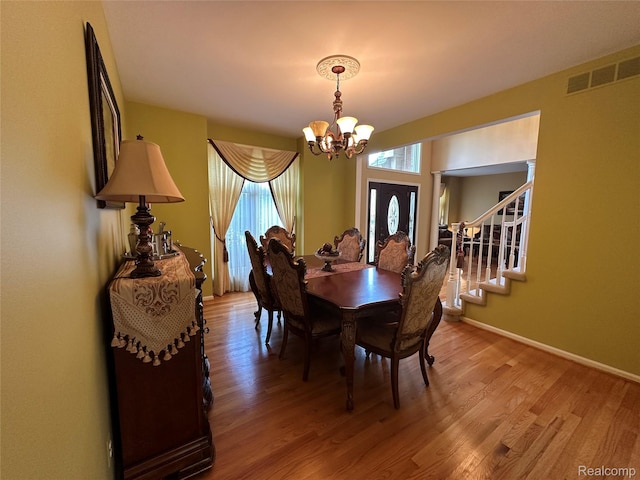 6601PEMBRIDGEHILL Pembridge Hl, West Bloomfield, MI 48322 - dining room featuring a chandelier, light wood-style floors, stairs, and baseboards