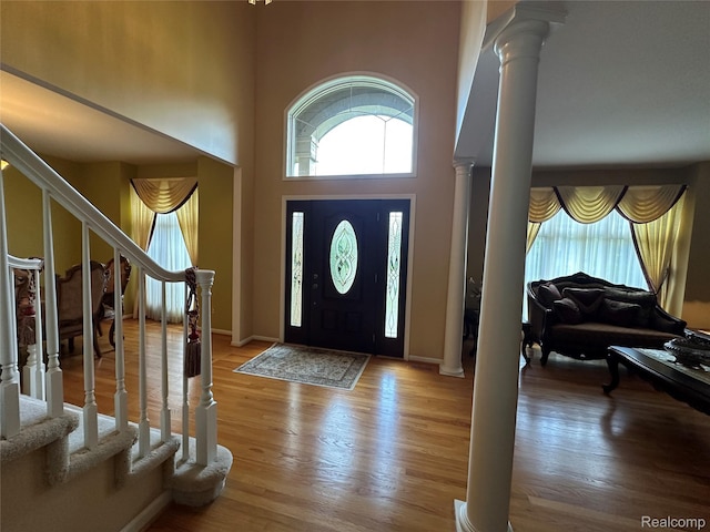 6601PEMBRIDGEHILL Pembridge Hl, West Bloomfield, MI 48322 - entrance foyer with decorative columns, plenty of natural light, stairs, wood finished floors, and a towering ceiling
