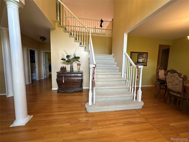 6601PEMBRIDGEHILL Pembridge Hl, West Bloomfield, MI 48322 - stairway featuring ornate columns, wood finished floors, baseboards, and a high ceiling