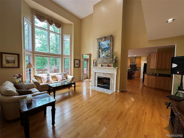 6601PEMBRIDGEHILL Pembridge Hl, West Bloomfield, MI 48322 - living area with high vaulted ceiling, light wood finished floors, a fireplace, and baseboards