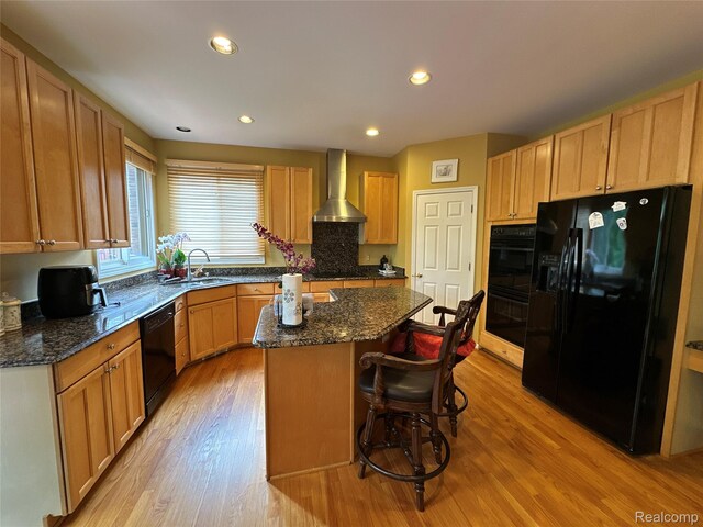 6601PEMBRIDGEHILL Pembridge Hl, West Bloomfield, MI 48322 - kitchen featuring black appliances, wall chimney exhaust hood, a sink, a center island, and light wood-style floors
