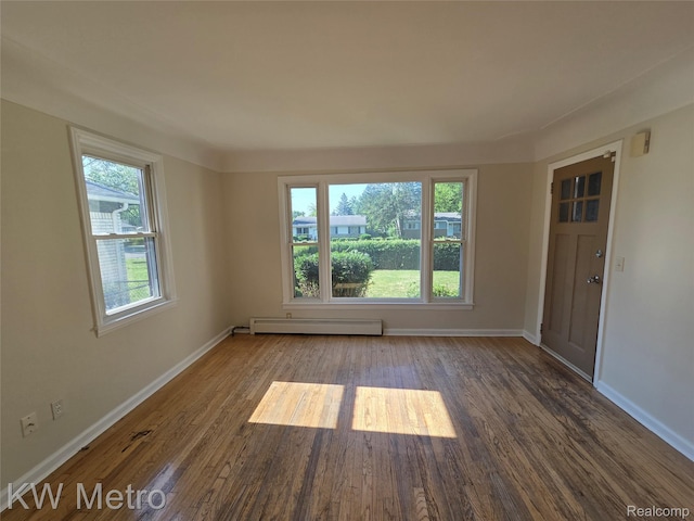 19620 Jeanette St, Southfield, MI 48075 - spare room with a baseboard heating unit, wood finished floors, and baseboards