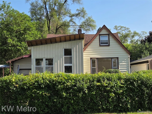 19620 Jeanette St, Southfield, MI 48075 - view of front of house with a chimney and board and batten siding