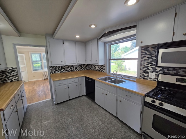 19620 Jeanette St, Southfield, MI 48075 - kitchen featuring appliances with stainless steel finishes, a sink, radiator, tasteful backsplash, and recessed lighting