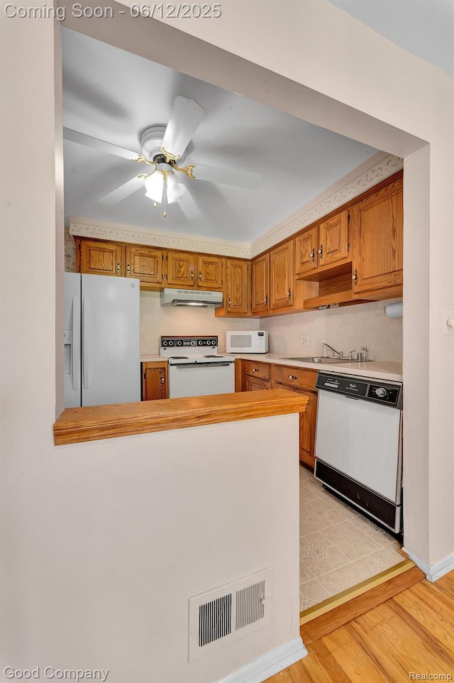 29628 Hoover Rd, Warren, MI 48093 - kitchen featuring white appliances, under cabinet range hood, light countertops, light wood finished floors, and a ceiling fan