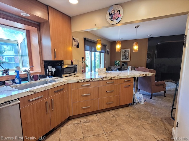17137 Hilton St, Southfield, MI 48075 - kitchen with stainless steel appliances, a peninsula, light stone counters, decorative light fixtures, and light tile patterned floors