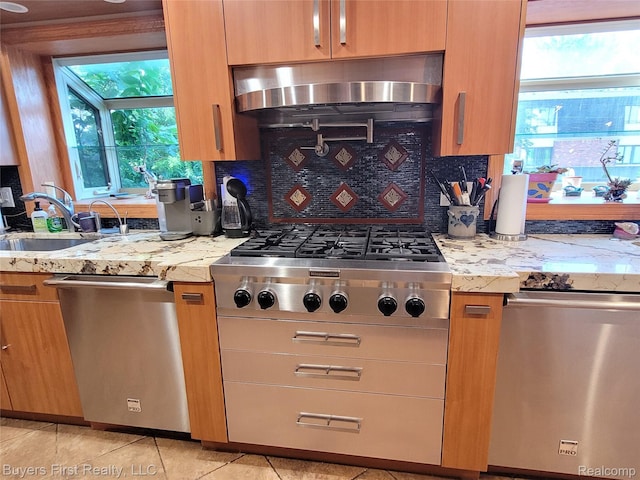 17137 Hilton St, Southfield, MI 48075 - kitchen with stainless steel appliances, wall chimney exhaust hood, backsplash, and light stone counters