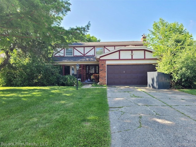 17137 Hilton St, Southfield, MI 48075 - tudor-style house featuring an attached garage, driveway, a front lawn, a chimney, and brick siding