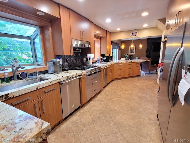 17137 Hilton St, Southfield, MI 48075 - kitchen featuring stainless steel appliances, a peninsula, decorative backsplash, light stone countertops, and decorative light fixtures