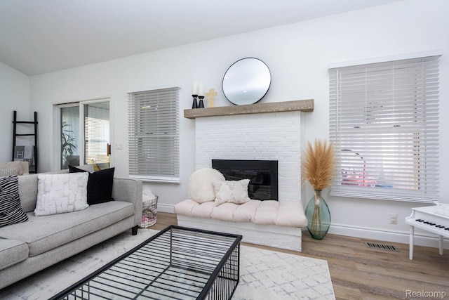 62874 Walker Ct Unit 17, Washington, MI 48094 - living room featuring wood finished floors and a brick fireplace