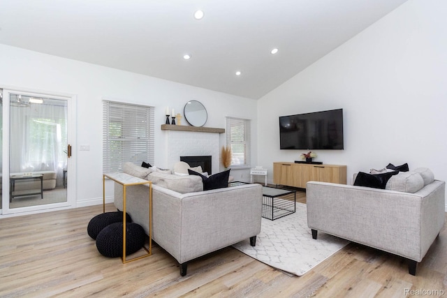 62874 Walker Ct Unit 17, Washington, MI 48094 - living area featuring light wood-style floors, healthy amount of natural light, a brick fireplace, recessed lighting, and high vaulted ceiling
