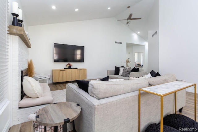 62874 Walker Ct Unit 17, Washington, MI 48094 - living room with a ceiling fan, light wood-style floors, high vaulted ceiling, a brick fireplace, and recessed lighting