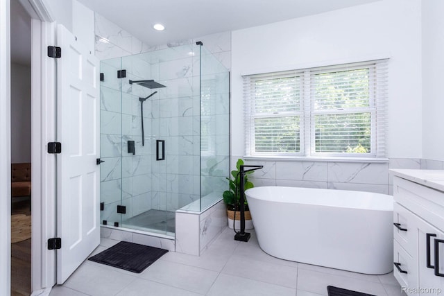 62874 Walker Ct Unit 17, Washington, MI 48094 - full bathroom with a shower stall, a freestanding tub, vanity, tile patterned flooring, and tile walls
