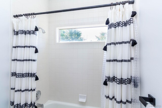 62874 Walker Ct Unit 17, Washington, MI 48094 - bathroom featuring shower / bath combination with curtain