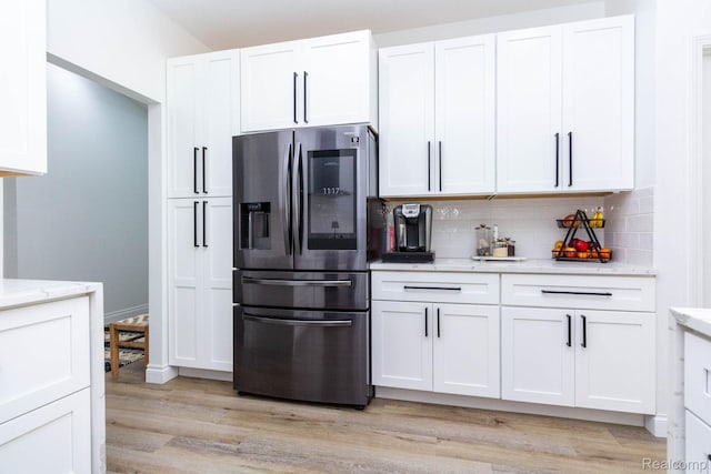 62874 Walker Ct Unit 17, Washington, MI 48094 - kitchen with stainless steel refrigerator with ice dispenser, white cabinets, light wood-style flooring, tasteful backsplash, and light stone countertops