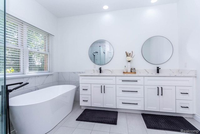 62874 Walker Ct Unit 17, Washington, MI 48094 - full bathroom with double vanity, a freestanding bath, tile patterned flooring, a shower with shower door, and tile walls