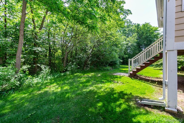 62874 Walker Ct Unit 17, Washington, MI 48094 - view of grassy yard featuring stairway