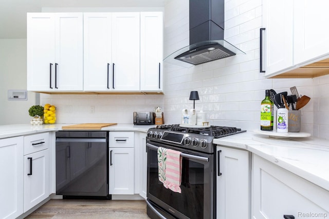 62874 Walker Ct Unit 17, Washington, MI 48094 - kitchen with stainless steel gas range oven, wall chimney range hood, black dishwasher, and white cabinetry