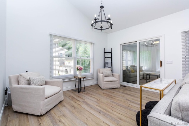 62874 Walker Ct Unit 17, Washington, MI 48094 - sitting room featuring a chandelier, light wood-style flooring, and high vaulted ceiling
