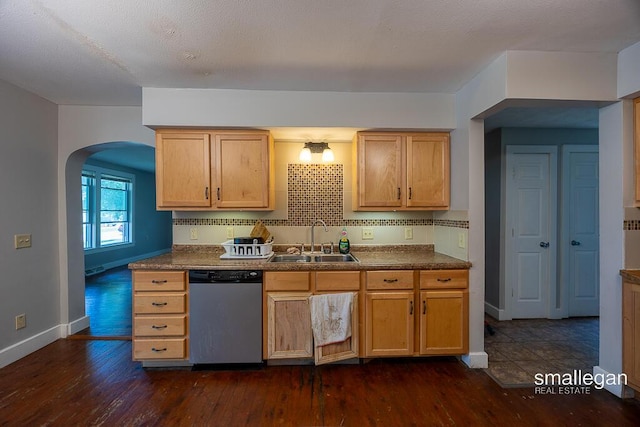 186 N Elm St, Sparta, MI 49345 - kitchen featuring stainless steel dishwasher, arched walkways, dark wood-style flooring, and dark countertops