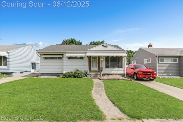 3809 Whittier Ave, Flint, MI 48506 - view of front facade featuring a front lawn, a chimney, roof with shingles, and concrete driveway