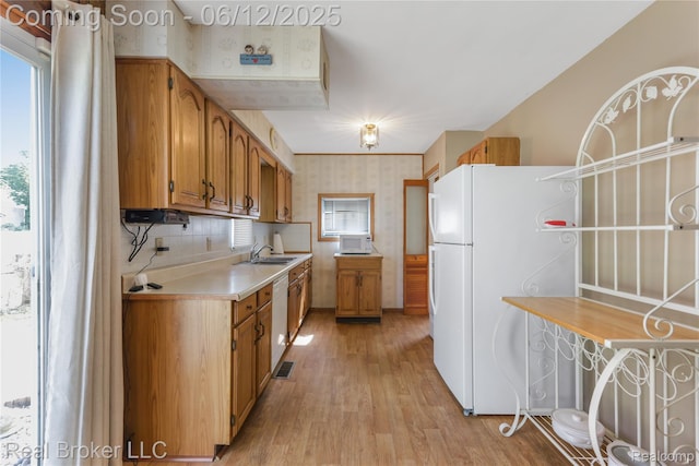 3809 Whittier Ave, Flint, MI 48506 - kitchen with wallpapered walls, white appliances, a sink, healthy amount of natural light, and light wood-style floors