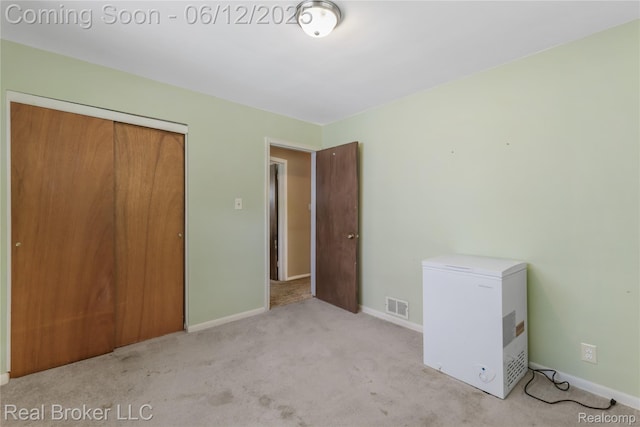 3809 Whittier Ave, Flint, MI 48506 - unfurnished bedroom featuring white fridge, carpet floors, baseboards, and a closet