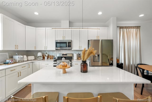 3947 Trailwaycommons Cir, Auburn Hills, MI 48326 - kitchen featuring appliances with stainless steel finishes, a breakfast bar area, backsplash, white cabinets, and recessed lighting