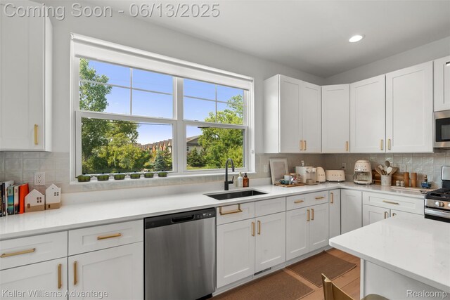 3947 Trailwaycommons Cir, Auburn Hills, MI 48326 - kitchen with appliances with stainless steel finishes, white cabinetry, decorative backsplash, light countertops, and recessed lighting