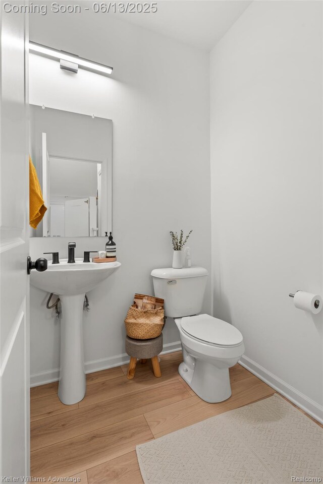 3947 Trailwaycommons Cir, Auburn Hills, MI 48326 - half bathroom with toilet and wood finished floors