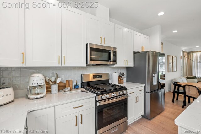 3947 Trailwaycommons Cir, Auburn Hills, MI 48326 - kitchen with appliances with stainless steel finishes, white cabinetry, light wood-style flooring, recessed lighting, and tasteful backsplash