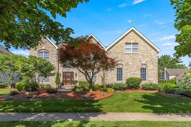 4991 Knollcrest Ct, Commerce Twp, MI 48382 - traditional home featuring a front lawn and brick siding