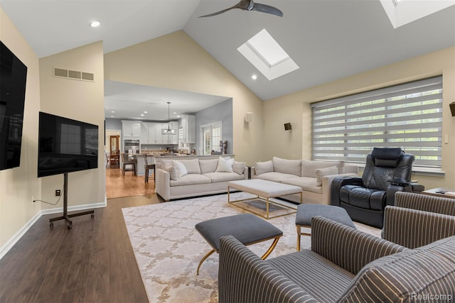 4991 Knollcrest Ct, Commerce Twp, MI 48382 - living area with a skylight, high vaulted ceiling, dark wood-style flooring, ceiling fan, and recessed lighting