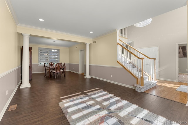 4991 Knollcrest Ct, Commerce Twp, MI 48382 - living room with decorative columns, stairway, crown molding, and wood finished floors