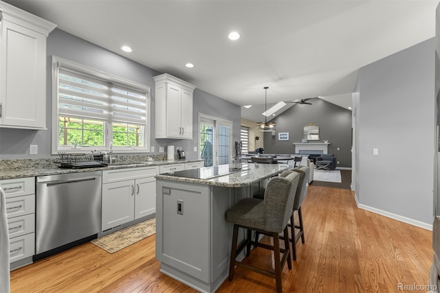 4991 Knollcrest Ct, Commerce Twp, MI 48382 - kitchen featuring dishwasher, open floor plan, a center island, white cabinetry, and light stone counters
