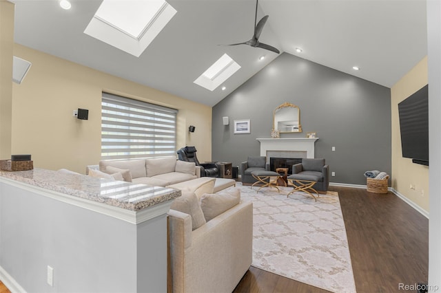 4991 Knollcrest Ct, Commerce Twp, MI 48382 - living area featuring a skylight, a fireplace, wood finished floors, high vaulted ceiling, and recessed lighting