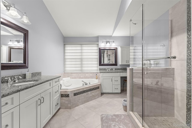4991 Knollcrest Ct, Commerce Twp, MI 48382 - bathroom featuring two vanities, a shower stall, a garden tub, and tile patterned flooring