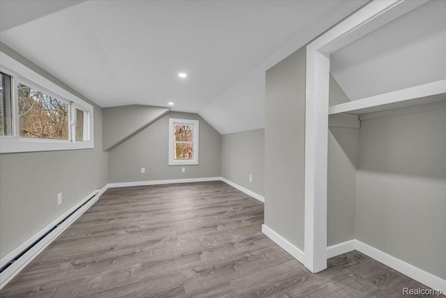 15907 Blackstone St, Detroit, MI 48223 - additional living space featuring baseboard heating, vaulted ceiling, recessed lighting, wood finished floors, and baseboards