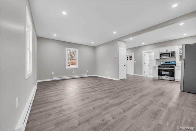 15907 Blackstone St, Detroit, MI 48223 - unfurnished living room with a baseboard radiator, baseboards, wood finished floors, and recessed lighting