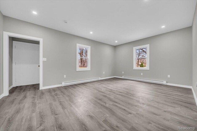 15907 Blackstone St, Detroit, MI 48223 - spare room with a baseboard radiator, wood finished floors, baseboards, and recessed lighting