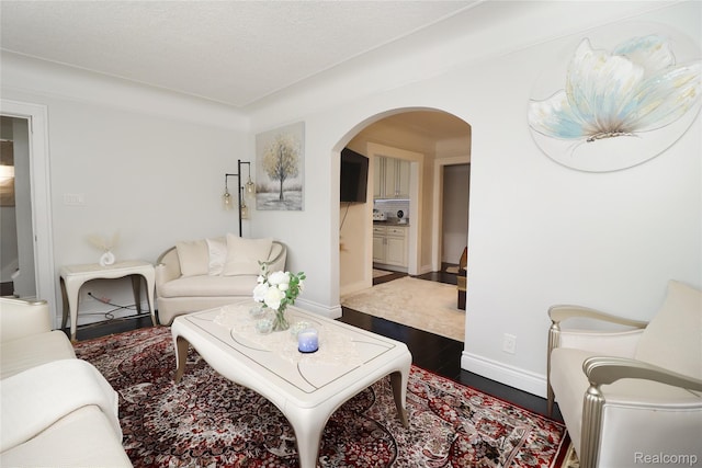 7524 Williamson St, Dearborn, MI 48126 - living area featuring arched walkways and dark wood-style flooring