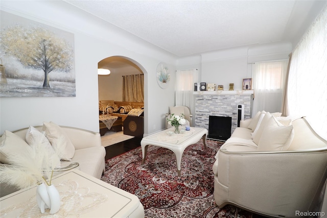 7524 Williamson St, Dearborn, MI 48126 - living area with arched walkways, a fireplace, and wood finished floors