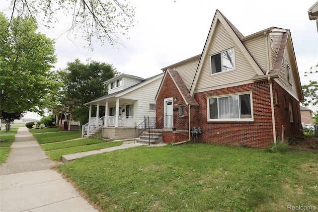 7524 Williamson St, Dearborn, MI 48126 - view of front of house featuring brick siding, a front yard, and covered porch