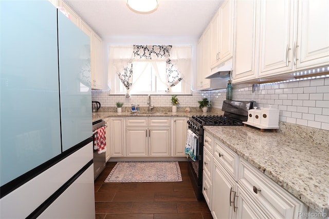 7524 Williamson St, Dearborn, MI 48126 - kitchen featuring gas range, freestanding refrigerator, tasteful backsplash, dark wood finished floors, and range